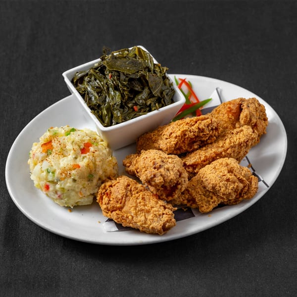 Next Phaze Cafe's soul food plate with fried chicken, mashed potatoes, and collard greens.