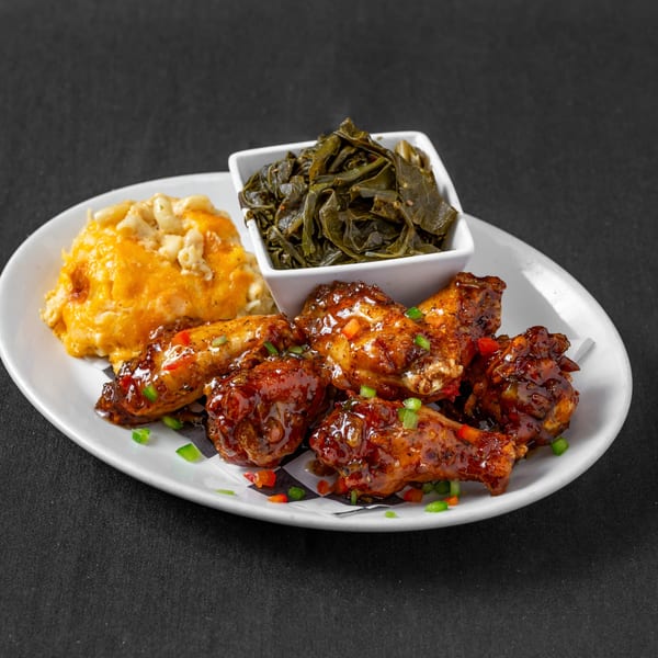 Next Phaze Cafe's soul food plate with BBQ wings, mac and cheese, and collard greens.
